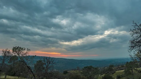 Incoming Storm Clouds and Sunset in California Forested Foothills Stock Footage 282297446