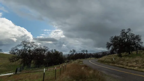 Incoming Storm Clouds Drop Rain and Darkness on Country Road Stock Footage 282394017