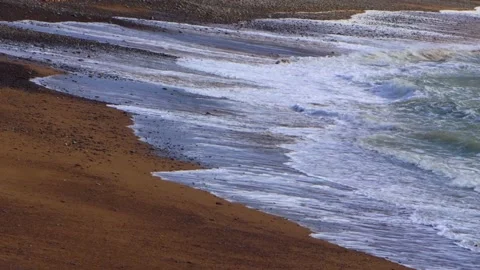 Incoming tide on sandy beach on windy day Stock Footage 132825009