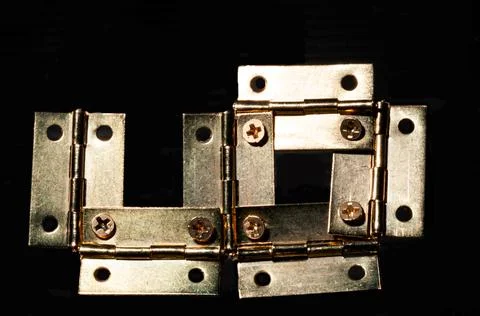 Incomplete brass hinges construction as a team building activity Stock Photos