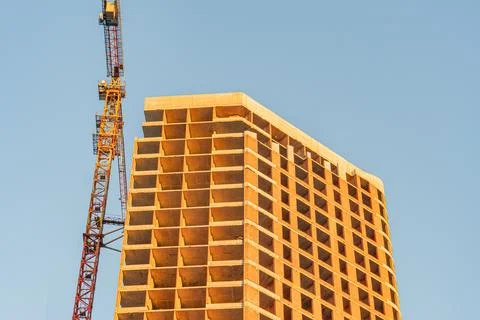 Incomplete building construction, wooden forms on concrete structure, yello.. Fotos de archivo