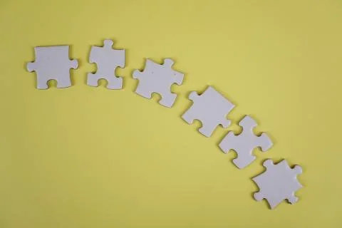 Incomplete half round of raw Jigsaw puzzle pieces background concept on yello Stock Photos