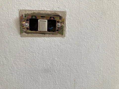 Incomplete light switch installation on a white plaster wall Stock Photos