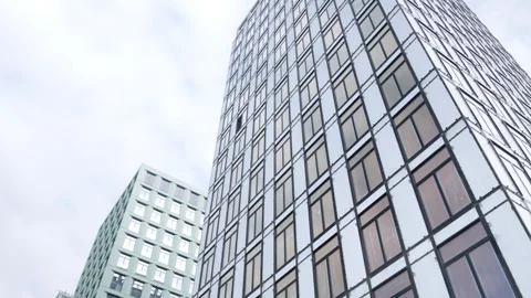 Incomplete office building facade with windows under sky Видео 330990811