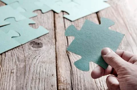 Incomplete puzzles lying on wooden rustic boards. Foto stock