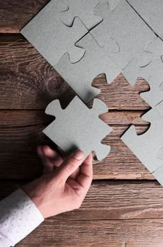 Incomplete puzzles lying on wooden rustic boards. Foto stock