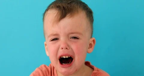 Inconsolably crying upset child looking at camera Stock Footage 116089737