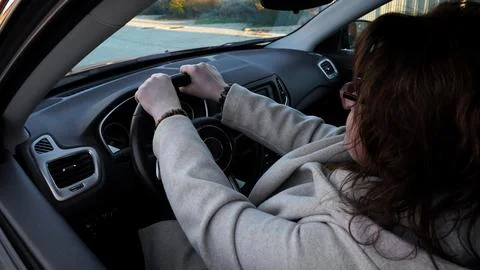 Incorrect hand position on the steering wheel of a car Stock Photos