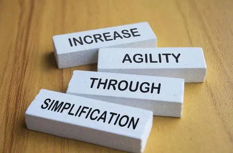 Increase agility through simplification text on white wooden blocks increa... Foto stock