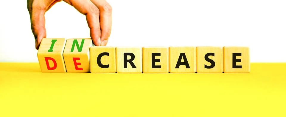 Increase or decrease symbol. Concept words Increase and Decrease on wooden cu Stock Photos