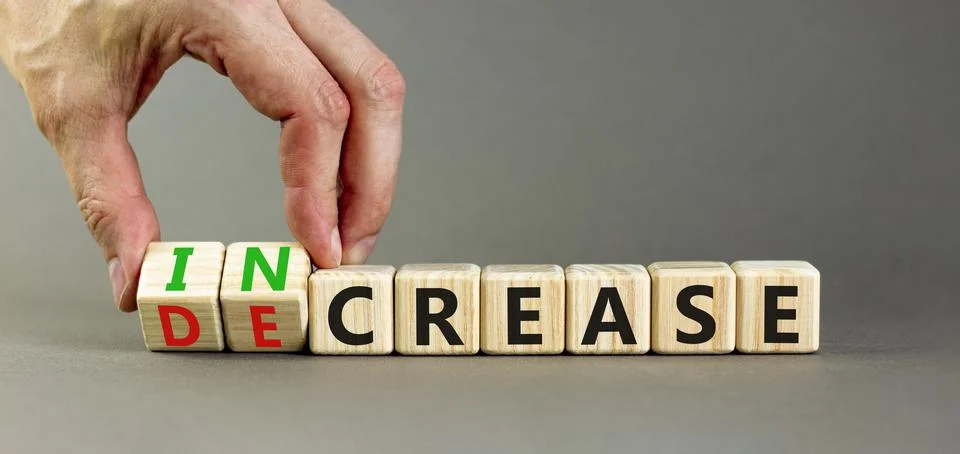 Increase or decrease symbol. Concept words Increase and Decrease on wooden cu Stock Photos