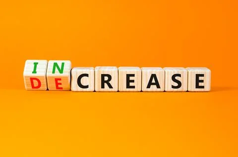 Increase or decrease symbol. Concept words Increase and Decrease on wooden cu 스톡 사진
