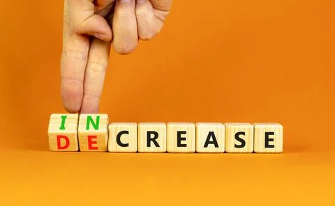 Increase or decrease symbol. Concept words Increase and Decrease on wooden cu Stock Photos