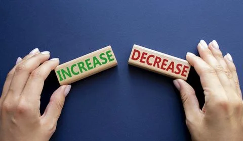 Increase or Decrease symbol. Concept word Increase or Decrease on wooden bl.. Stock Photos