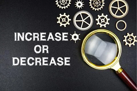 Increase Or Decrease text message with magnifying glass on black background Stock Photos