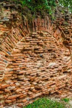 Increased vegetation on one side of the brick ruin Fotos de archivo