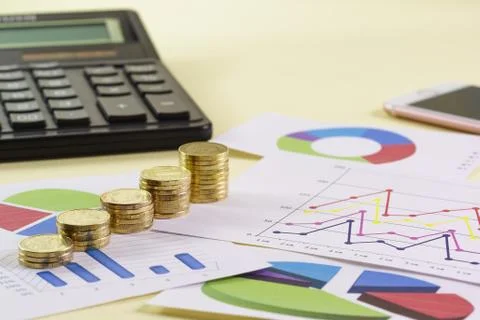 Increasing in the size of the stack of gold coins are on colored charts Stock Photos