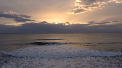 Incredible circling camera move as surfers ride crashing waves Stock Footage 112695260