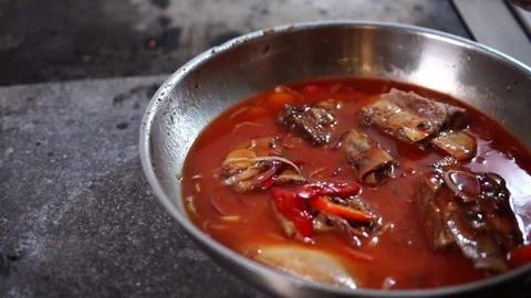 Incredible detailed close up view on chef cook adding salt and pepper to pork Stock Footage 106813428