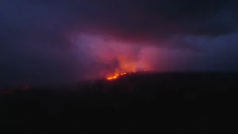 Incredible dramatic volcanic eruption, flyover above lava river flowing Hawaii Video stock 237266505
