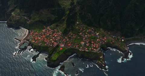 Incredible drone view of the small town of Seixal located on the leaked volcanic Stock Footage 266013423
