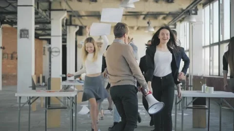 Incredible fun in the office. Employees dance, scatter money and paper, a Stock Footage 165386489