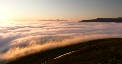 Incredible midnight sun drone view over sea fog cloud inversion over Tromso Stock Footage 323189395