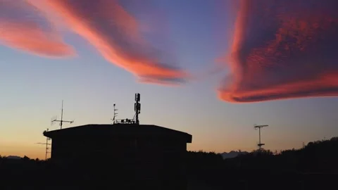 Incredible sky with pink orange clouds over houses, static Видео 278844111