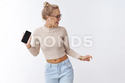 Incredible sound. Indoor shot of amused and enthusiastic charismatic blond Stock Photos