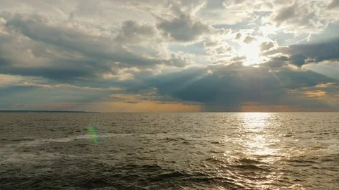 Incredible sunset by the sea, the rays of the sun shine from a thundercloud Stock Footage 76749141