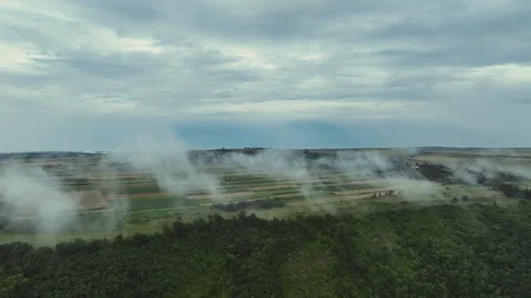 An incredible view of a planted field through the clouds Video stock 253225216