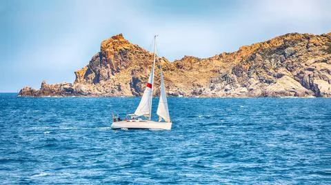 Incredible view of sailboat sailing near the cliffs of  Santa Teresa Gallura Stock Photos