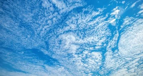 .incredibly deep sky with white clouds in the rays of the sun Stock Photos