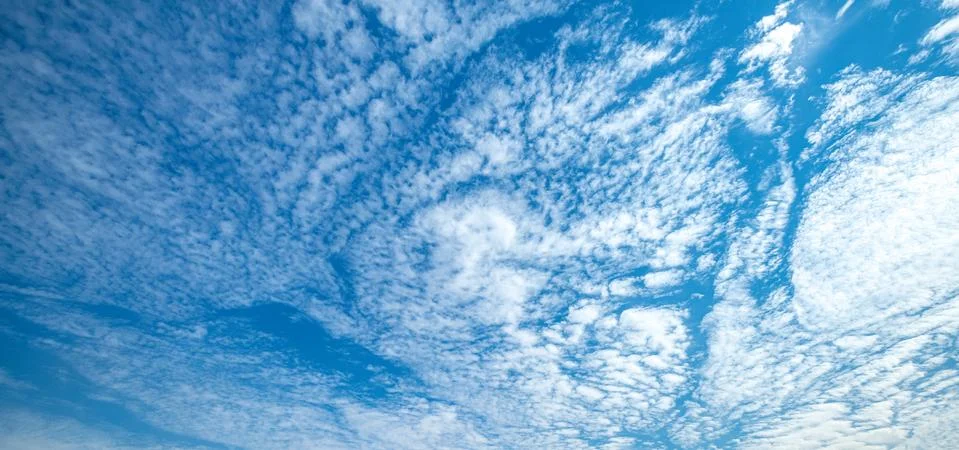 .incredibly deep sky with white clouds in the rays of the sun Stock Photos