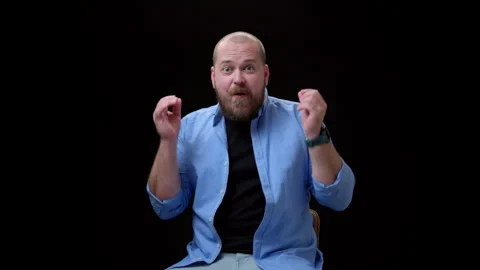 Incredibly happy guy throws his hands up and rejoices, looking at camera Stock Footage 252688895