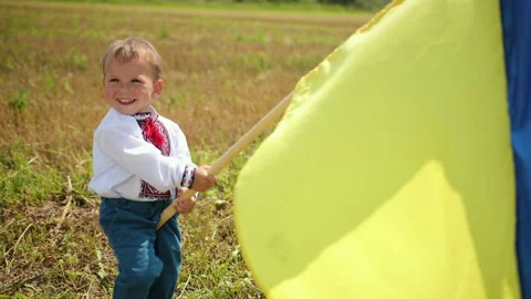 Independence day concept. Boy holding national flag of Ukraine, 動画素材 152801150