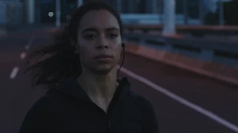 Independent athlete woman running in city at night exercising female runner Stock Footage