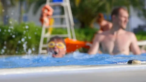 Independent boy learns to dive and swim in a warm pool during summer holidays 스톡 동영상 236885921