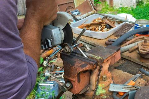 Independent tool making using a vise and angle grinder, hands of a wizard, work Stock Photos