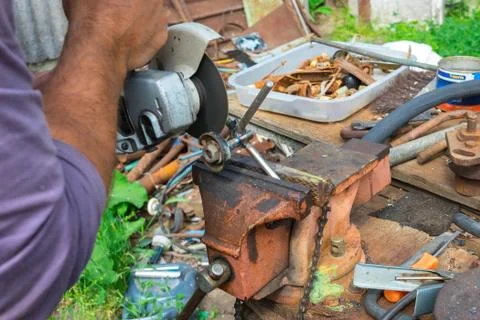 Independent tool making using a vise and angle grinder, hands of a wizard, work Stock Photos