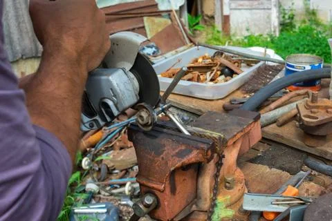 Independent tool making using a vise and angle grinder, hands of a wizard, work Stock Photos