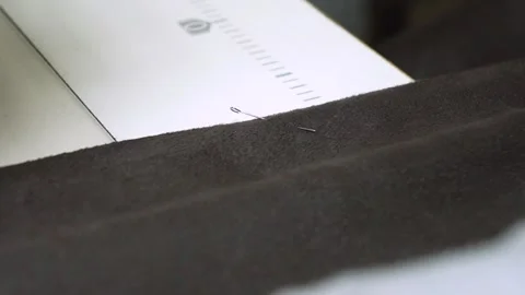 An InDepth Look at the Sewing Process Involving Fabric Preparation and Pin Setup Stock Footage 310260357