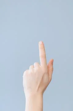 Index finger up on blue background with space for text Stock Photos