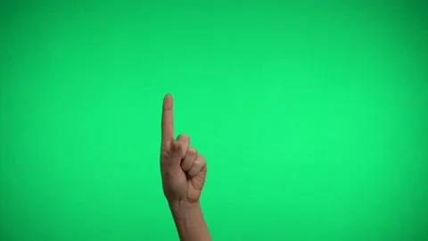 The index finger indicates the direction on a green background. Video stock 163600172