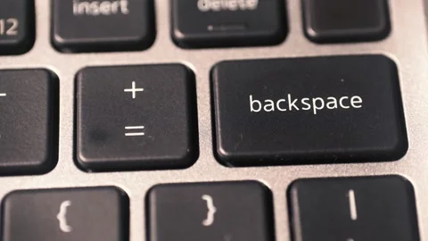 The index finger presses the BACKSPACE key on the laptop keyboard. Video stock 327247579