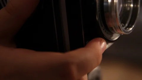 Index finger presses the shutter button of a vintage medium format camera Stock Footage 112508507