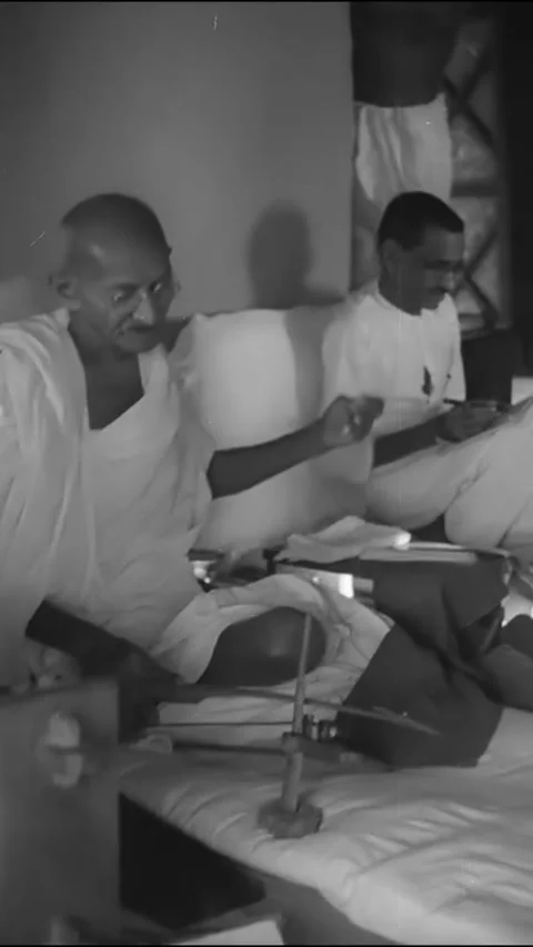 INDIA - 1942 - Gandhi plays a stringed instrument for men gathered in his home. Stock Footage 342628773