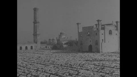 INDIA - 1945: Domed Complex and Minaret Across Open Ground Stock Footage 342856418