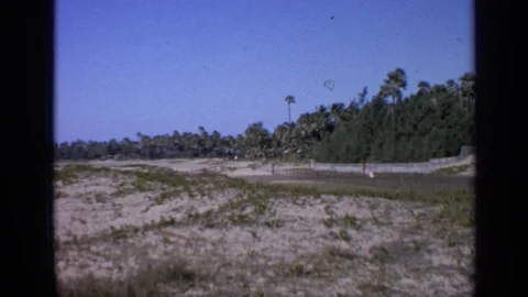 INDIA-1970: A Runner Runs Down A Dirt Track While Women Wearing White Dresses Vídeos de archivo 125009523