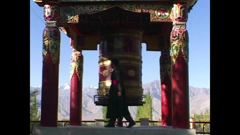 INDIA - 1999 - A Buddhist uses a prayer wheel in India. Stock Footage 341673243
